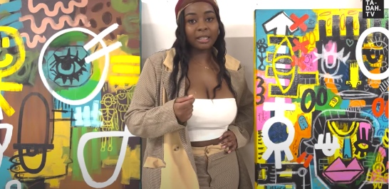 Charmaine Chanakira standing in between two of her paintings